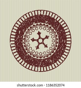 Red ninja star icon inside distressed rubber stamp with grunge texture