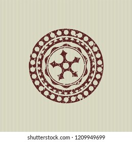 Red ninja star icon inside distressed rubber seal