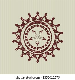 Red ninja star icon inside distress rubber seal
