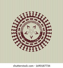 Icono de estrella de ninja roja dentro de la textura de caucho