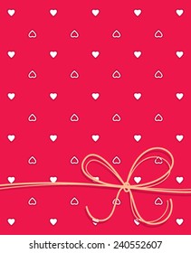 Red notebook cover or greeting card with hearts and ribbon.