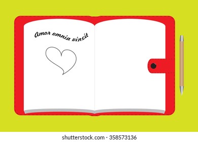 Red notebook with latin aphorism written by hand means "Love conquers the all" and drawn heart