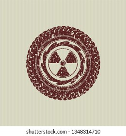 Red nuclear, radioactive icon inside distress rubber stamp