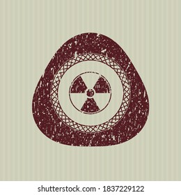 Red nuclear, radioactive icon inside distress with rubber seal texture. 