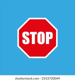 Red octagonal stop sign is conveying a message of stopping and ceasing on a vibrant blue backdrop.