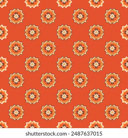 A red and orange floral patterned fabric. The pattern is made up of small circles and triangles. Scene is warm and inviting