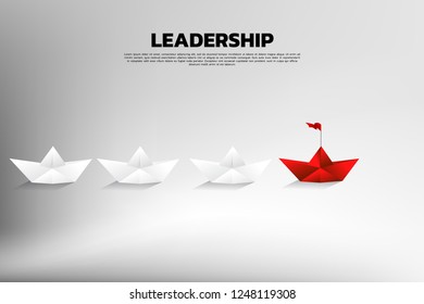 Red origami paper ship leading the group of white. Business Concept of team leadership.