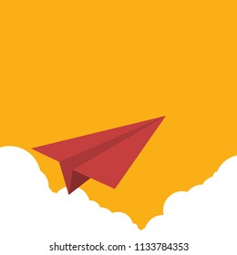 Red paper airplane flying over clouds