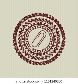 Red paper clip icon inside distress rubber stamp