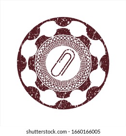 Red paper clip icon inside rubber grunge texture stamp