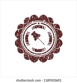 Red paper pin icon inside rubber stamp with grunge texture