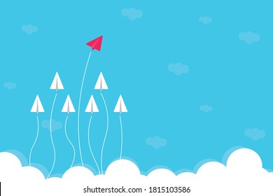  Red paper plane leading white airplanes above clouds in the sky. Business leadership concept.