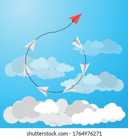 red paper plane leads grey ones on a sky background. Leadership, teamwork.