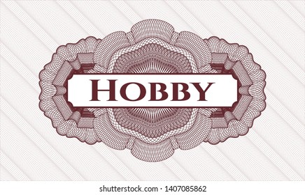 Red passport money style rosette with text Hobby inside