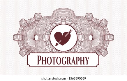 Red passport money style rosette with heart with arrow icon and Photography text inside