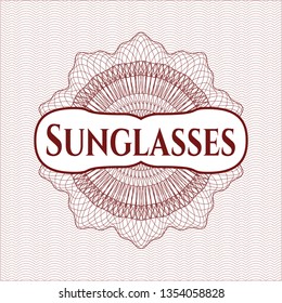 Red passport rosette with text Sunglasses inside