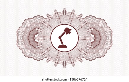 Red passport style rosette with desk lamp icon inside