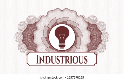 Red passport style rosette with light bulb icon and Industrious text inside