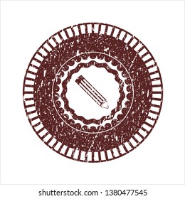 Red pencil icon inside distressed rubber grunge stamp