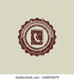 Red phonebook icon inside rubber texture