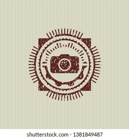 Red photo camera icon inside rubber grunge texture seal
