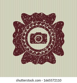 Red photo camera icon inside distress rubber stamp