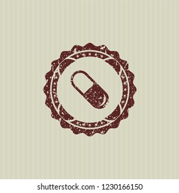 Red pill icon inside rubber grunge seal
