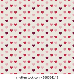 The red and pink hearts located close to each other on the light background.