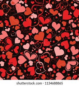 Red and pink hearts seamless pattern over dark background