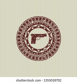 Red pistol icon inside grunge stamp