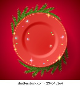 Red plate on the table, decorated with christmas tree branches. Holiday design. 