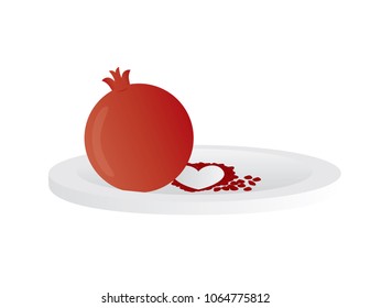 Red pomegranate on white plate isolated