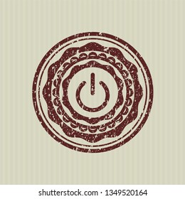 Red power icon inside distressed rubber seal with grunge texture