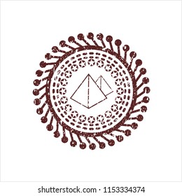 Red pyramids icon inside distress rubber seal