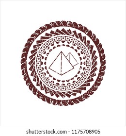 Red pyramids icon inside distress rubber grunge texture stamp