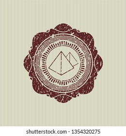 Red pyramids icon inside distressed with rubber seal texture