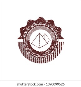 Red pyramids icon inside distressed rubber grunge seal