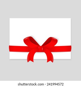 Red ribbon wrapping over a blank envelope