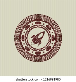 Red rocket icon inside distressed rubber grunge texture stamp