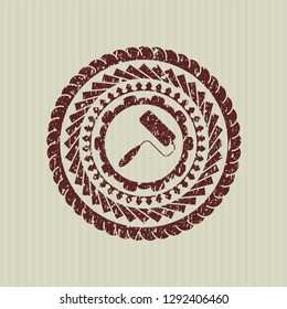 Red roller brush icon inside distressed rubber stamp with grunge texture