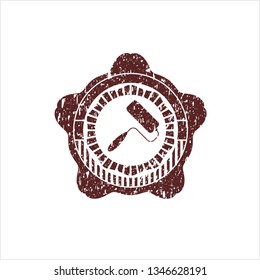 Red roller brush icon inside grunge seal