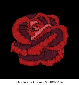 Red rose embroidery on black background.