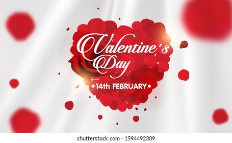 red rose petals heart shape on white fabric background.