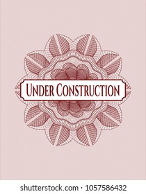 Red rosette or money style emblem with text Under Construction inside
