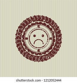  Red sad face icon inside distressed grunge seal
