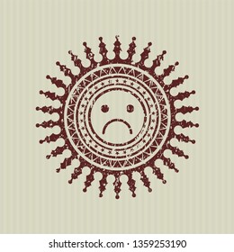 Red sad face icon inside distress rubber texture