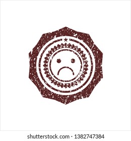 Red sad face icon inside rubber grunge texture stamp