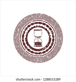 Red sand clock icon inside distressed rubber seal
