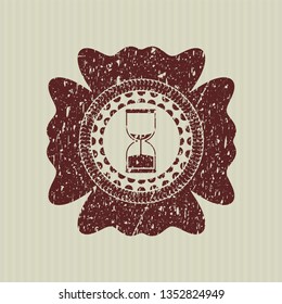 Red sand clock icon inside distressed rubber stamp