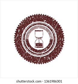 Red sand clock icon inside rubber grunge texture seal
